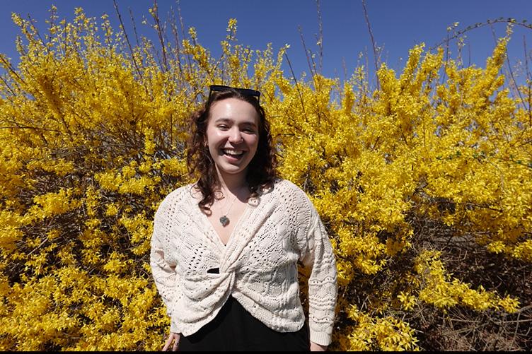 Woman standing in front of a bright yellow tree